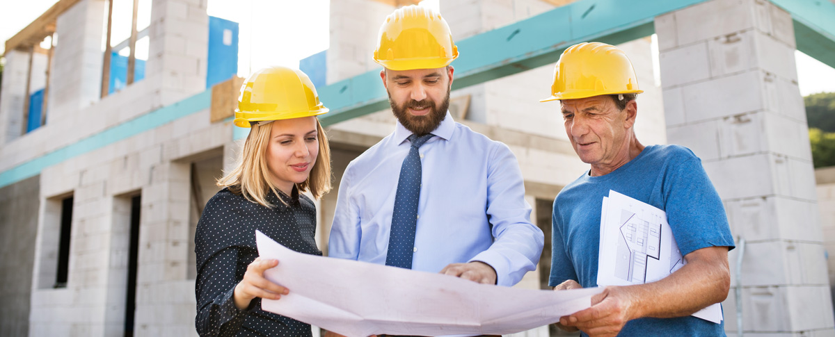 Contractors and project personnel reviewing work at a commercial site